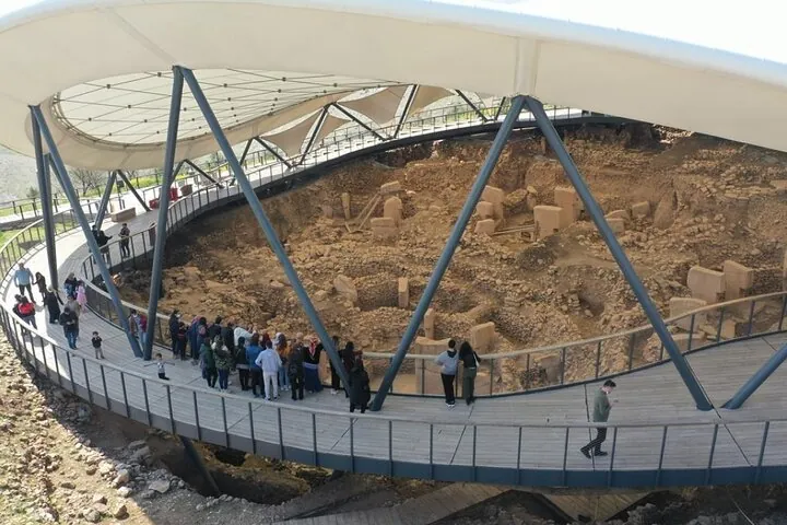 Visitors on the curved walkway around the main excavation on a Gobekli Tepe tour of three days from Şanlıurfa, Turkey
