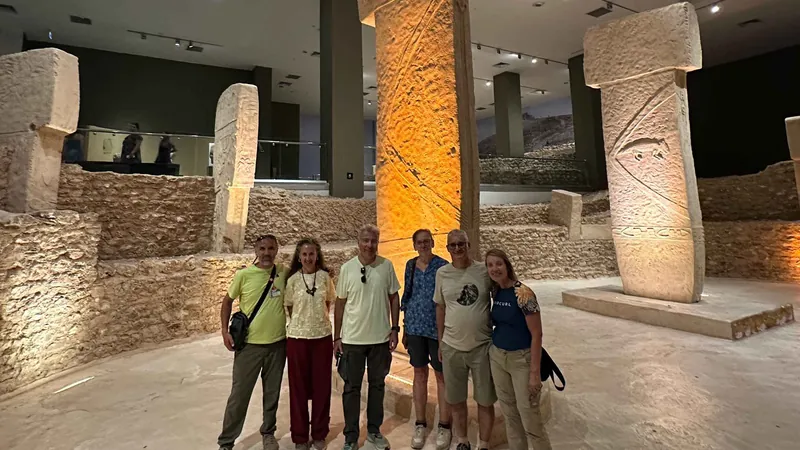 A group with their guide among replica pillars in the Şanlıurfa Archaeology Museum on a Gobekli Tepe tour, Turkey